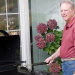 The Premiala Stainless Steel Grill Brush in use