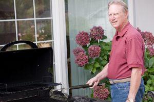 The Premiala Stainless Steel Grill Brush in use